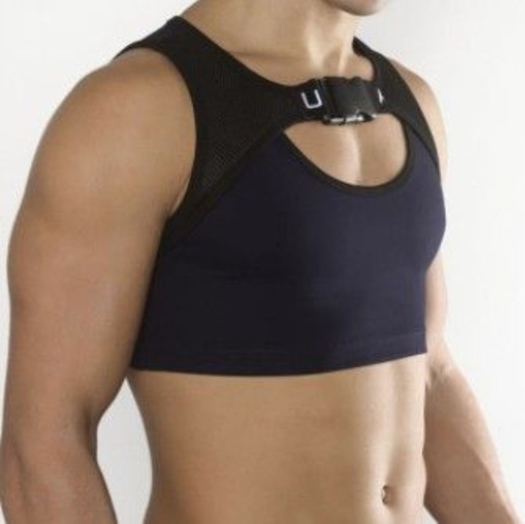 A close-up of a person wearing a black sports top with a supportive harness-style strap around the shoulders, highlighting the importance of support during workouts.