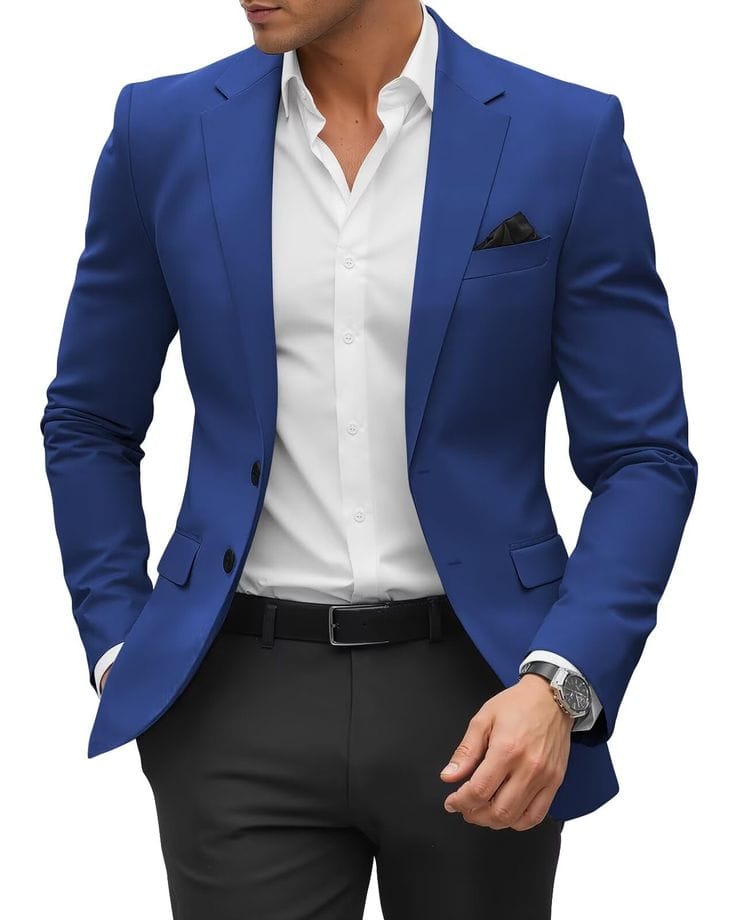 A man wearing a white polo shirt paired with a bright blue sport coat, black trousers, and a black belt, accessorized with a watch and a pocket square.