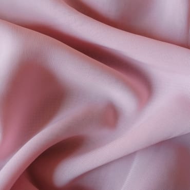 Polyester chiffon fabric in a soft, pastel color with gentle folds, suitable for everyday wear.