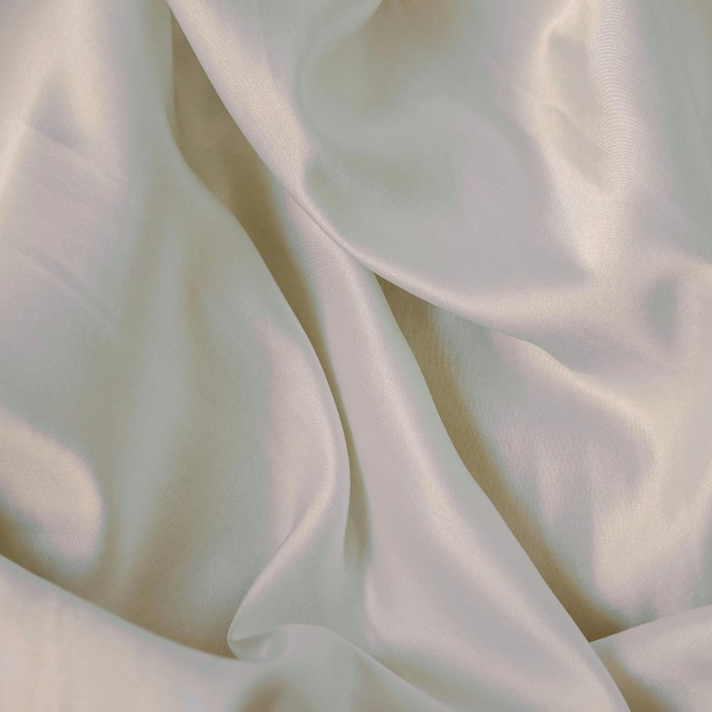 Close-up image of smooth, flowing pure chiffon fabric with soft folds and a shiny, delicate surface.