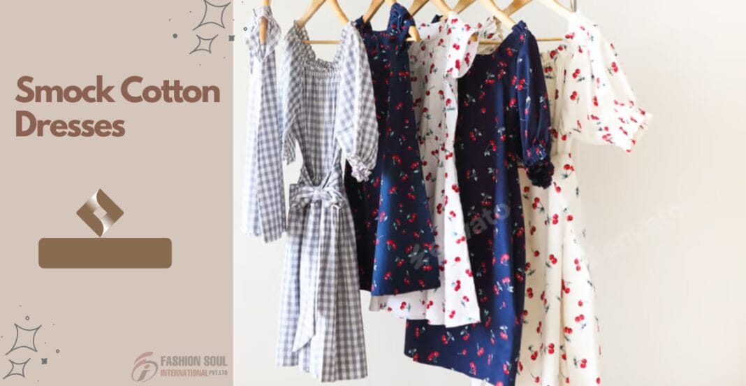 A display of five cotton dresses hanging on a rack. The dresses feature various floral and checkered patterns in shades of blue, white, and red, with some having smock details and puffed sleeves.