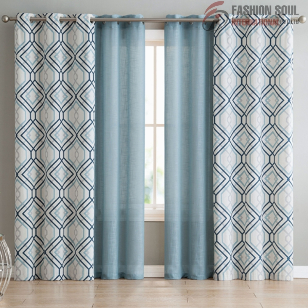 Light blue patterned and solid blue curtains hanging on a window with a simple rod in a bright room.