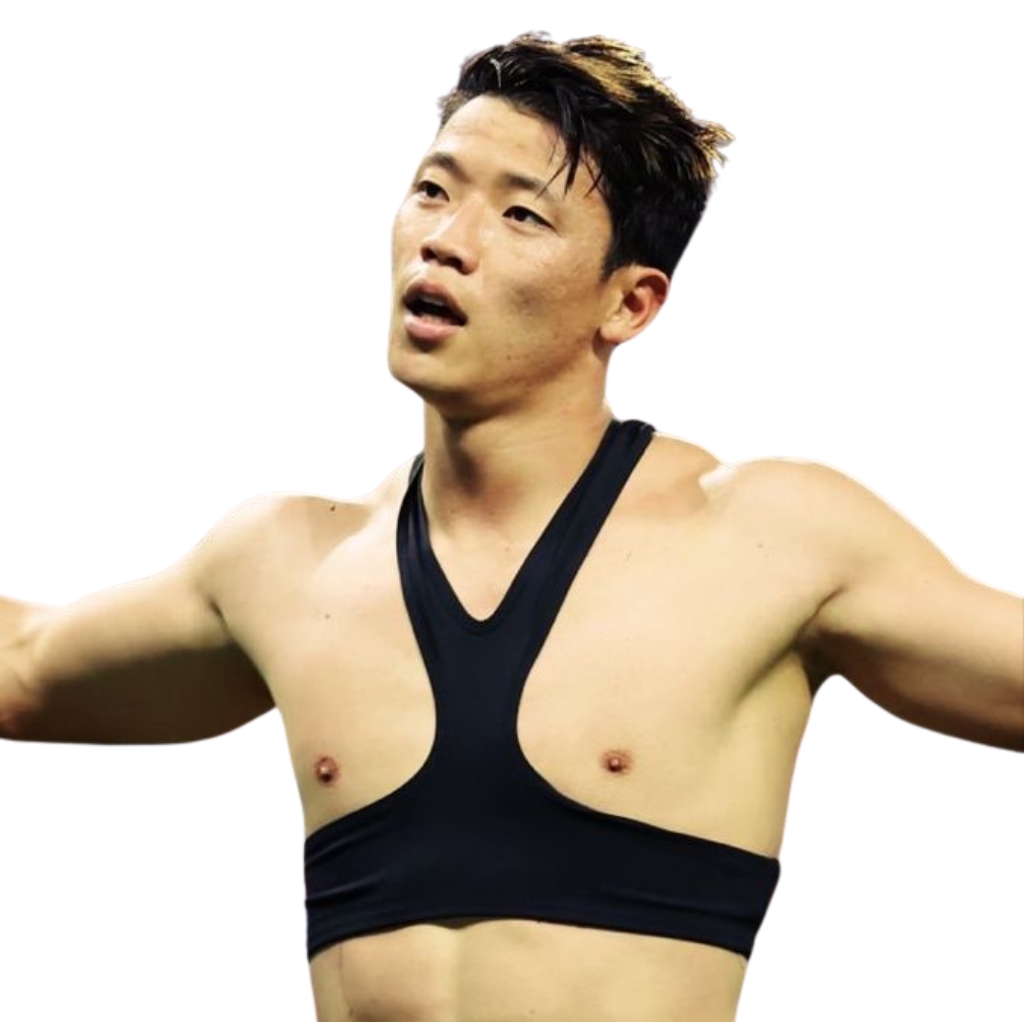 A muscular man wearing a black sports bra, standing with arms outstretched, demonstrating how men can wear sports bras.