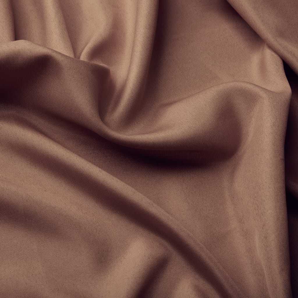 : A close-up of smooth, light brown polyester-spandex fabric with gentle folds and slight sheen.