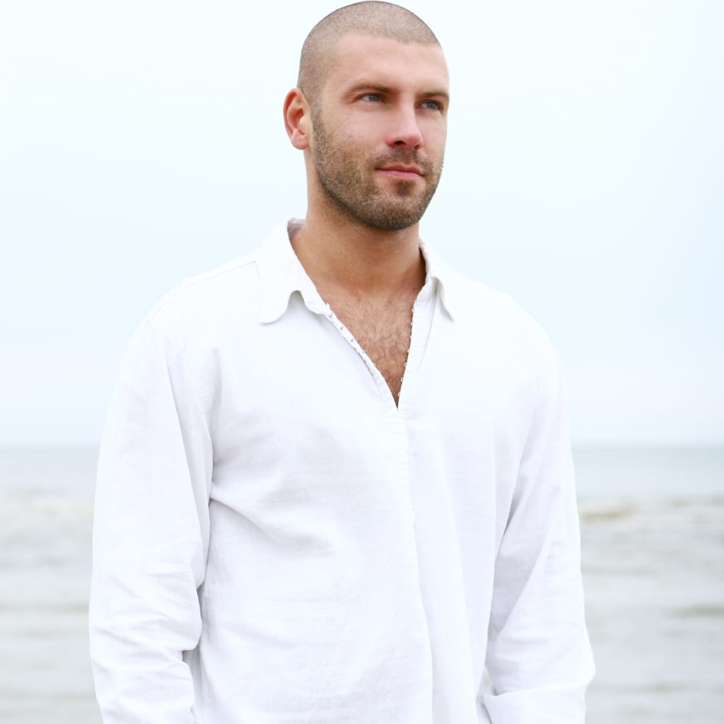 Light-colored cotton summer shirt with short sleeves and breathable fabric.