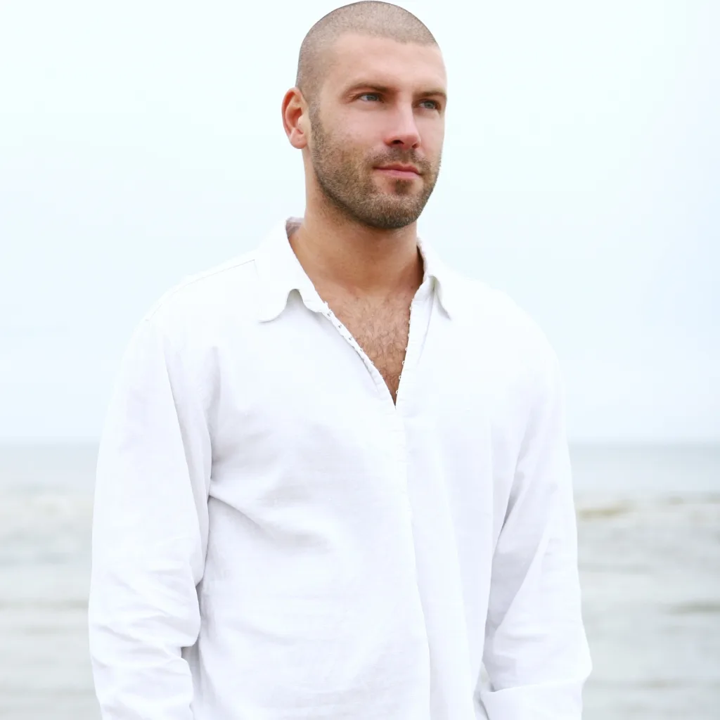 Light-colored cotton summer shirt with short sleeves and breathable fabric.