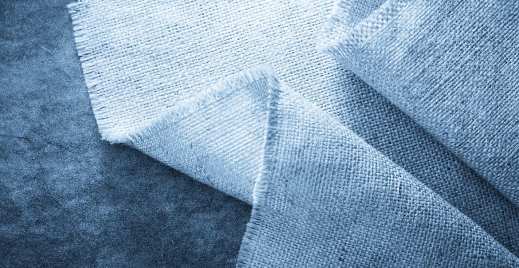 Light blue denim chambray fabric with a textured weave, partially folded.