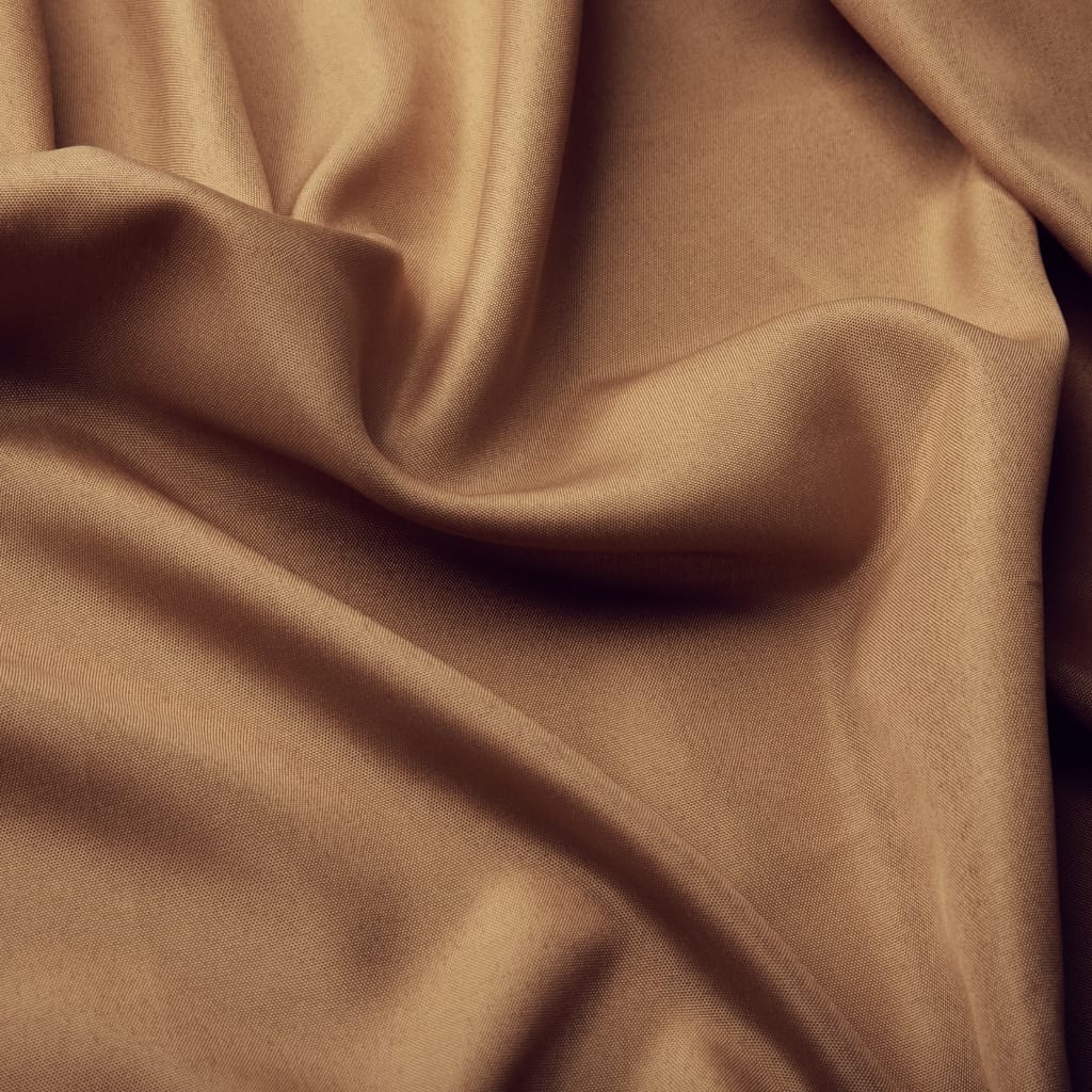 Close-up image of smooth, beige acetate fabric with soft folds and subtle sheen, commonly used in fashion apparel and accessories.
