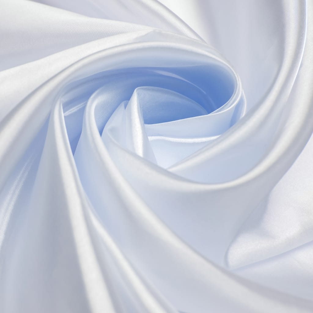 Close-up of elegant, sheer white silk organza fabric softly draped and forming delicate folds.