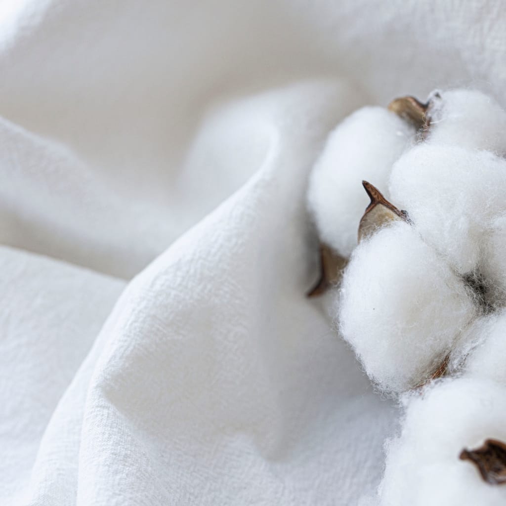 Close-up of long-staple cotton fabric showing its smooth, fine, and tightly woven fibers.