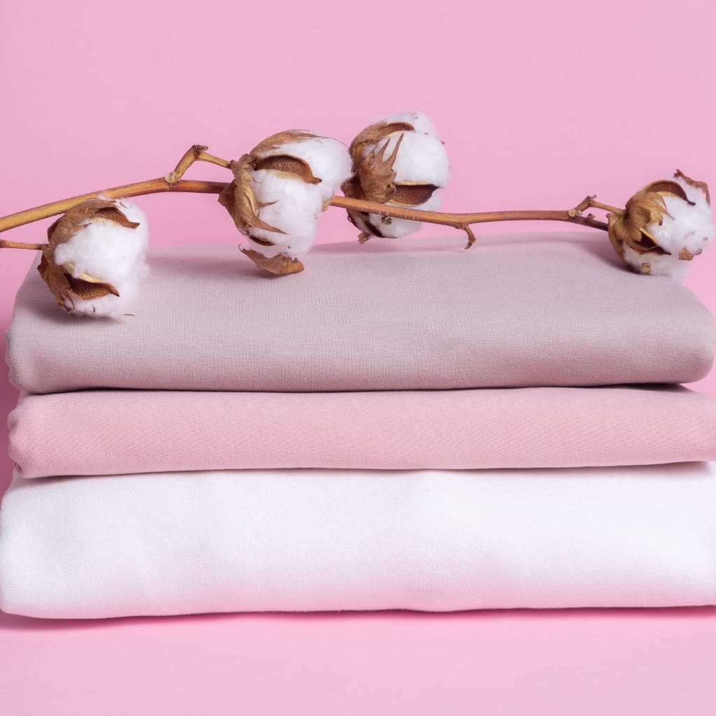 A variety of cotton fabrics showcasing different textures and weaves, emphasizing the importance of selecting the right cotton fabric for clothing.