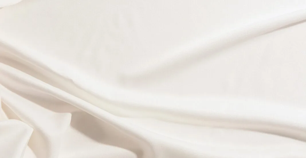 premium cotton fabric A close-up image of smooth, luxurious, and soft premium cotton fabric with gentle folds and a silky sheen.