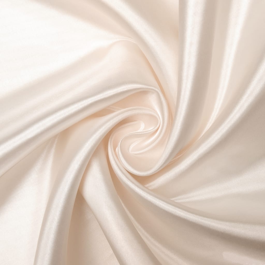 Close-up image of luxurious, shiny, ivory satin organza fabric twisted in a spiral.
