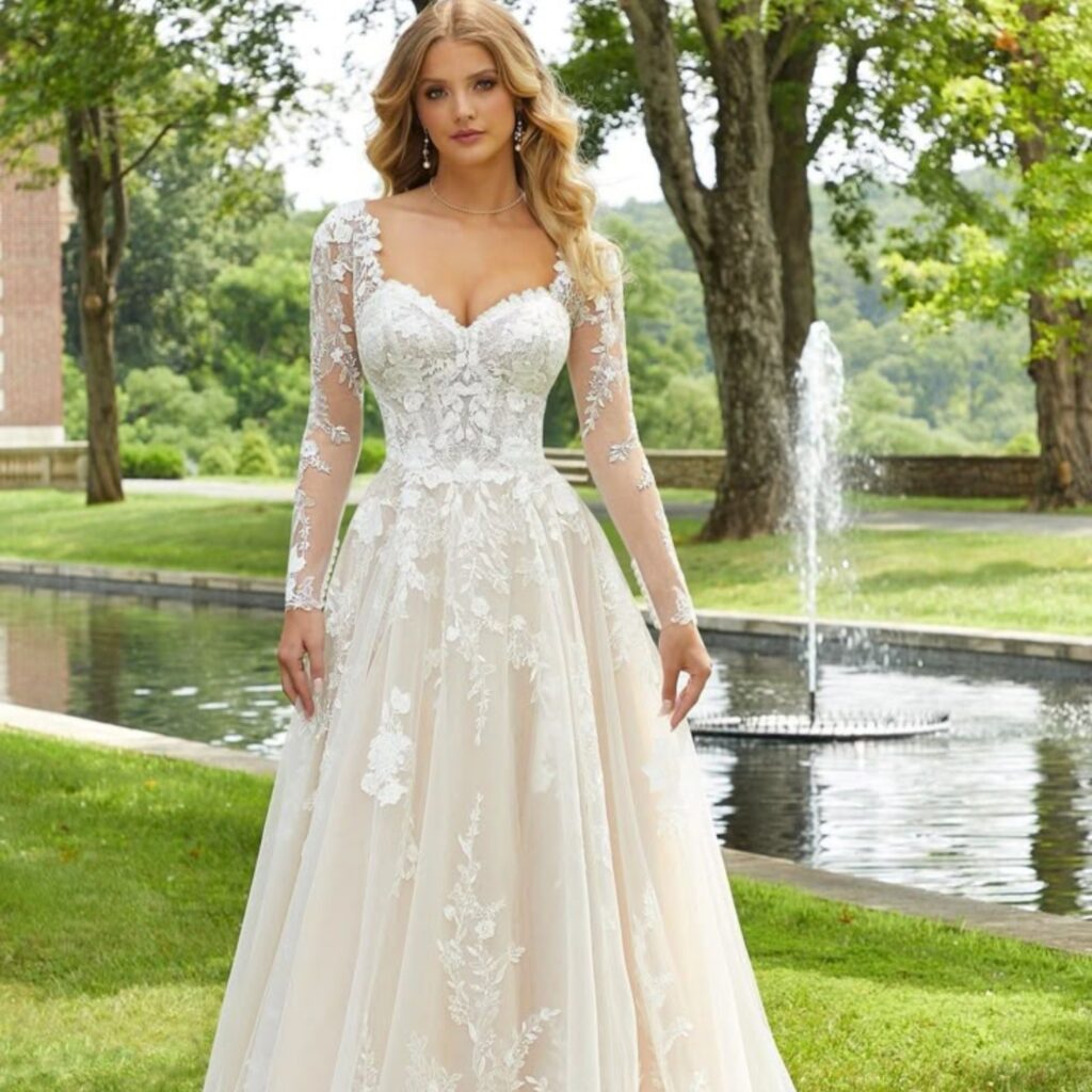 A close-up of an elegant white wedding dress with intricate lace details and a flowing train.