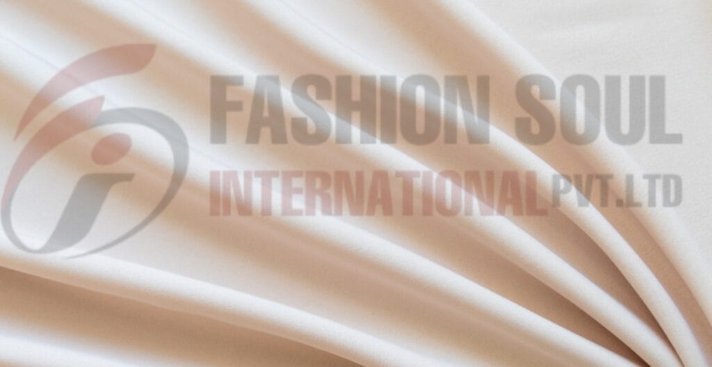 A close-up view of cream-colored satin fabric with a semi-transparent logo of "Fashion Soul International Pvt Ltd" printed on it.