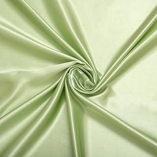Light green satin fabric twisted in the center to showcase its smooth and shiny texture.