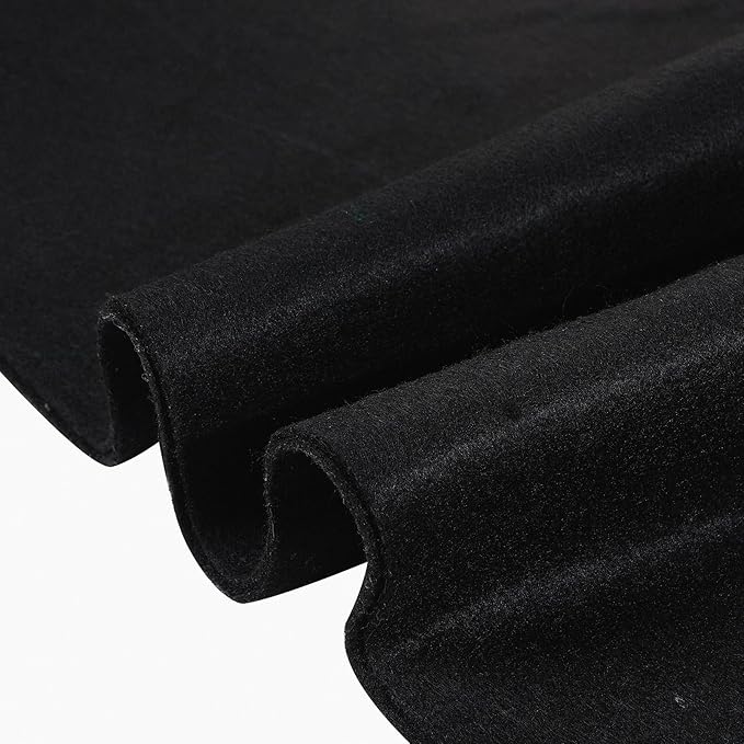 Close-up of folded black velvet fabric with a soft, plush texture.