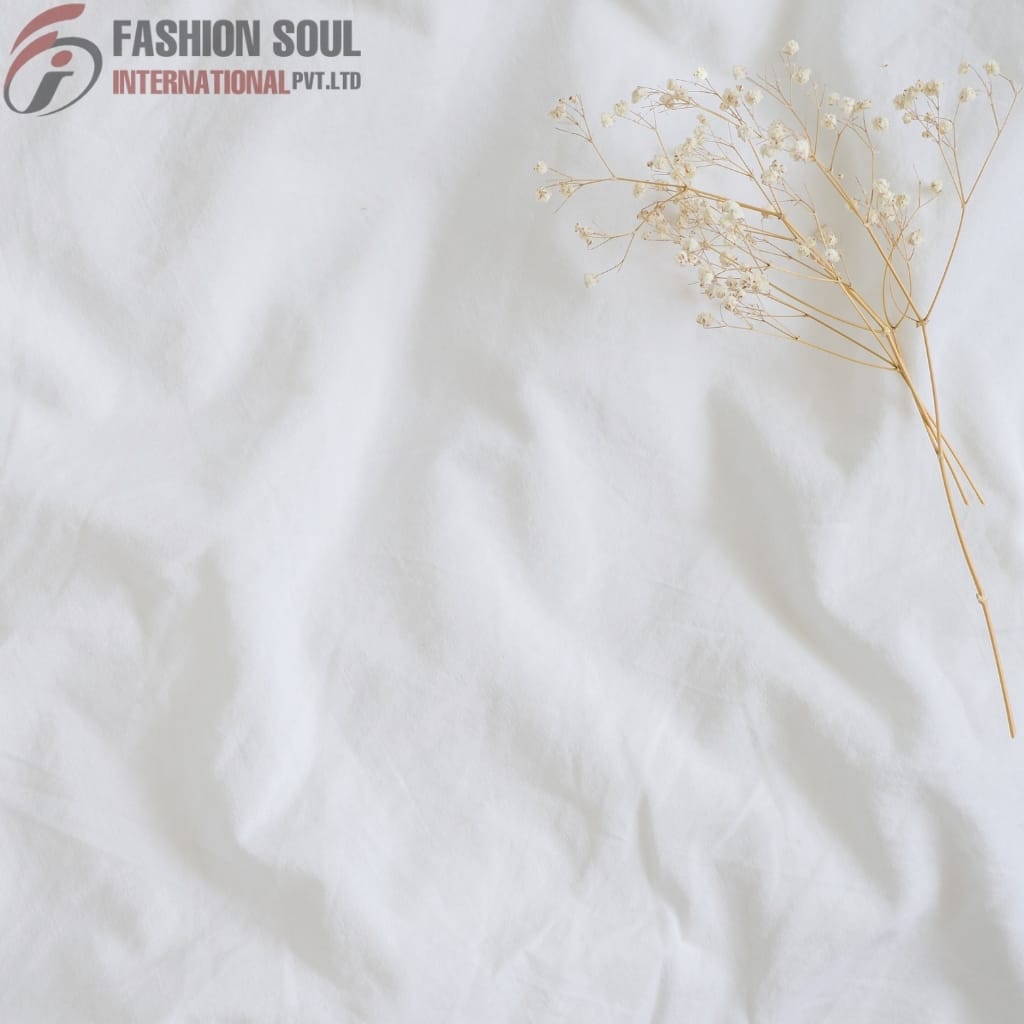 A crumpled white paper background with a delicate dried flower arrangement on the right side and the logo of "Fashion Soul International Pvt. Ltd." in the top left corner.