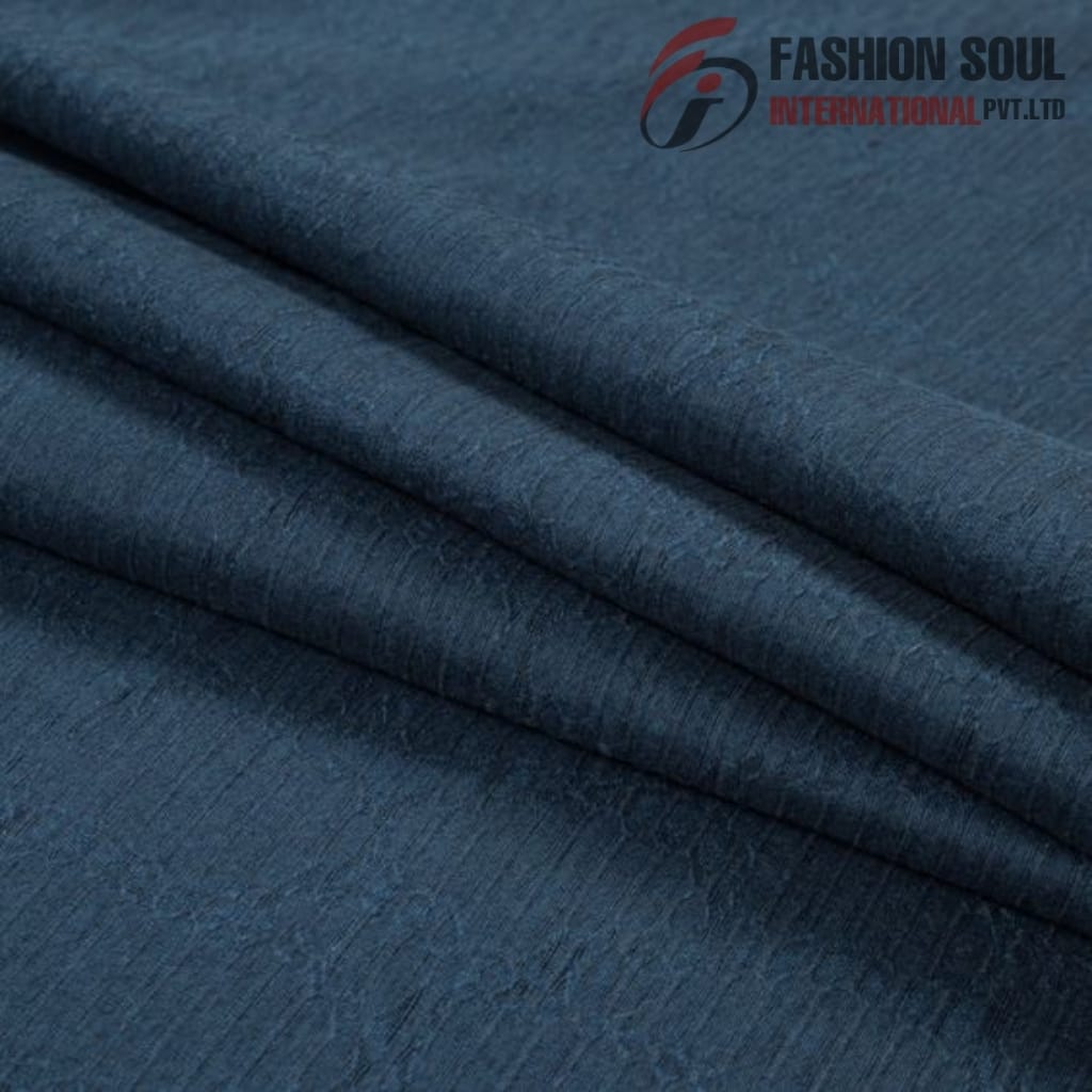 Close-up of folded dark blue denim fabric with a textured surface.