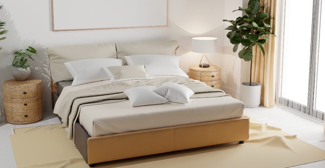 A modern bedroom featuring a large bed with neutral-toned bedding, two round wicker nightstands with potted plants, a table lamp, a large potted plant in a white planter, and floor-to-ceiling windows with light curtains allowing natural light to fill the room.