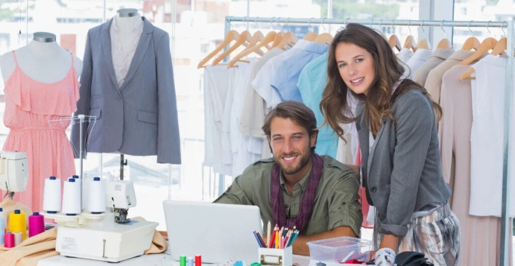 A diverse group of shoppers examining fabrics at a bustling fabric market, with swatches and fashion sketches pile on a table, symbolizing consumer influence on apparel materials.