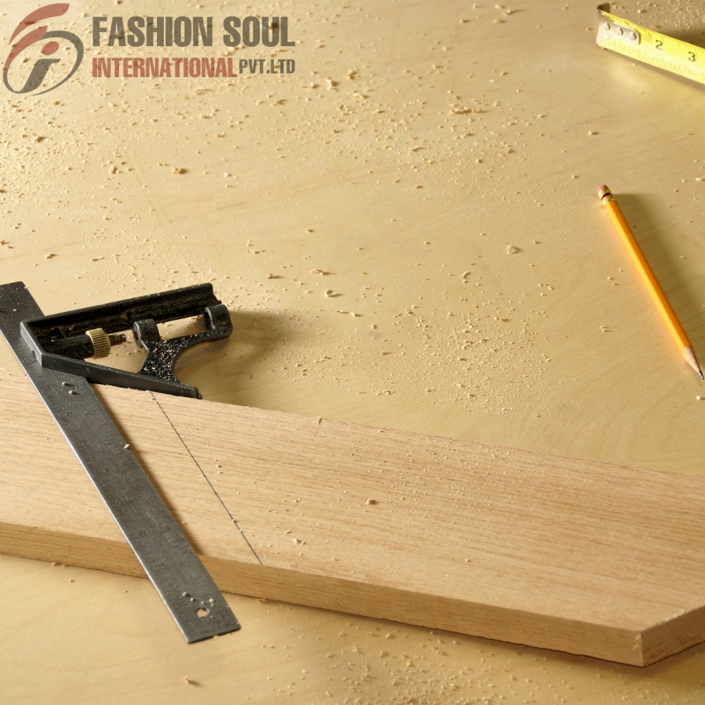 Close-up of a woodworking scene featuring a wooden board, a square, a pencil, and a measuring tape on a work surface.