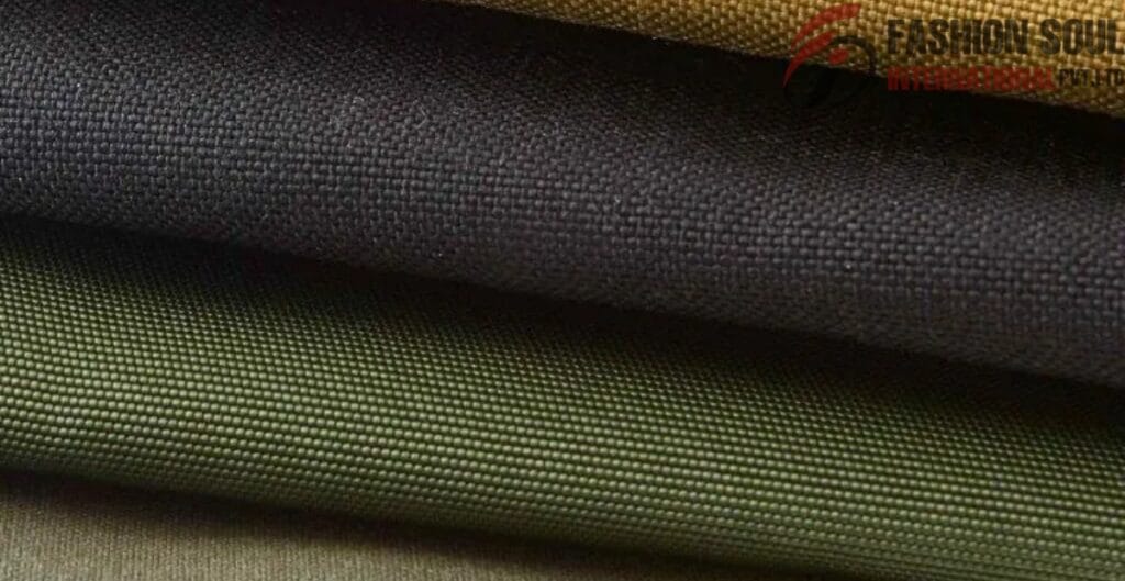 Close-up view of four stacked pieces of fabric in different colors, with a textured weave pattern.
