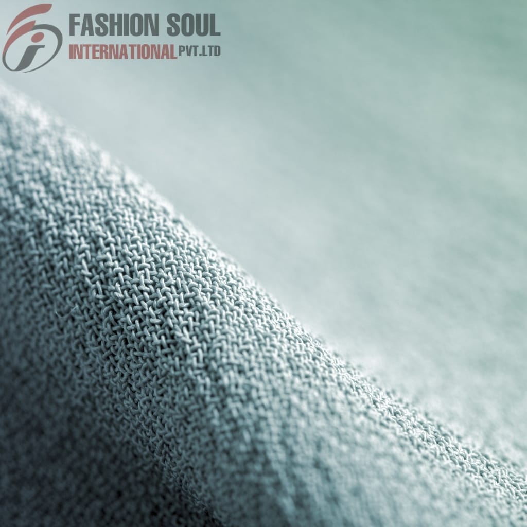 Close-up of smooth, light-colored fabric with a subtle texture and fine weave.