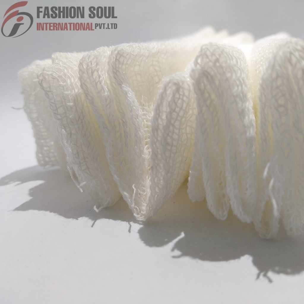 A close-up photograph of white loofah sponges arranged standing upright on a white surface, with shadows cast behind them. In the top left corner, there is a logo and text reading "FASHION SOUL INTERNATIONAL PVT.LTD."