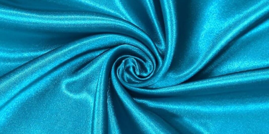 Swirled turquoise satin fabric with a smooth, glossy texture.