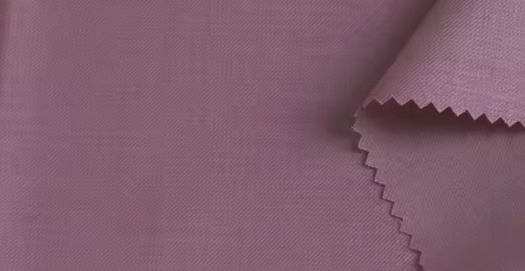 Close-up of mauve-colored fabric swatches with a zigzag-cut edge