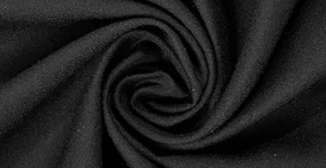 Close-up of black fabric swirled into a spiral pattern.