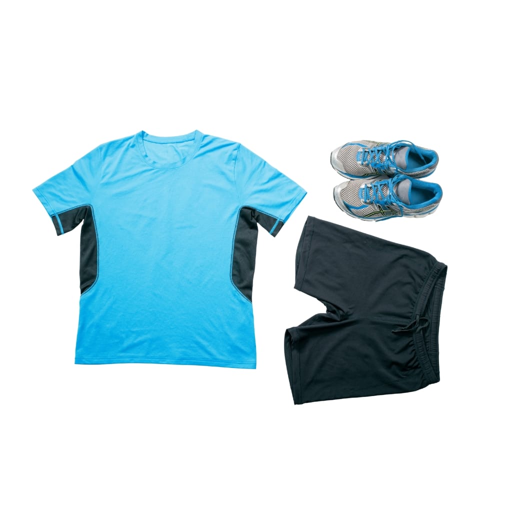 A set of athletic gear including a light blue and black sports t-shirt, black athletic shorts, and gray-blue running shoes arranged on a white background.