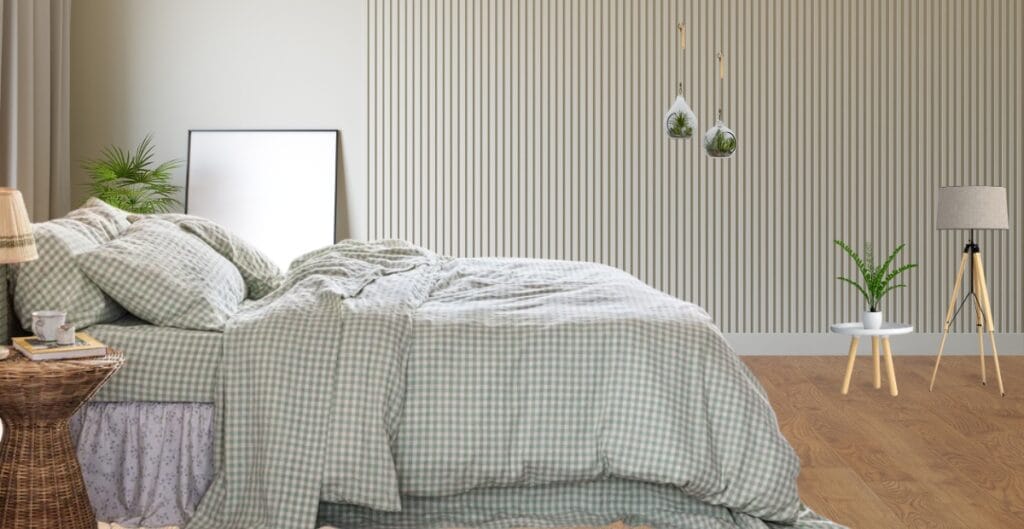A neatly made bed with cool-toned linen sheets, showcasing natural texture and relaxed folds.