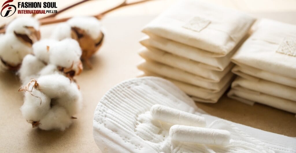 A collection of white sanitary pads and cotton balls, with some cotton on the left side and a stack of wrapped sanitary pads on the right, all placed on a beige surface.