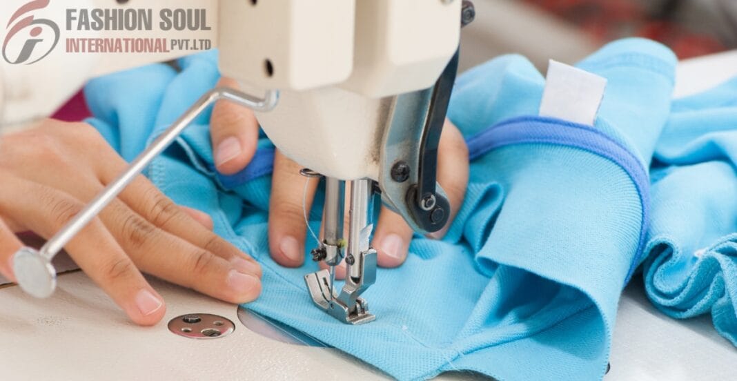 Close-up of a person sewing a light blue fabric with a sewing machine, focusing on the hands guiding the material.