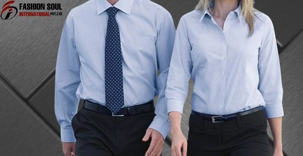 Two people in business attire walking side by side; the person on the left is wearing a light blue shirt with a dotted dark blue tie and black pants, while the person on the right is dressed in a light blue shirt with rolled-up sleeves and dark pants.