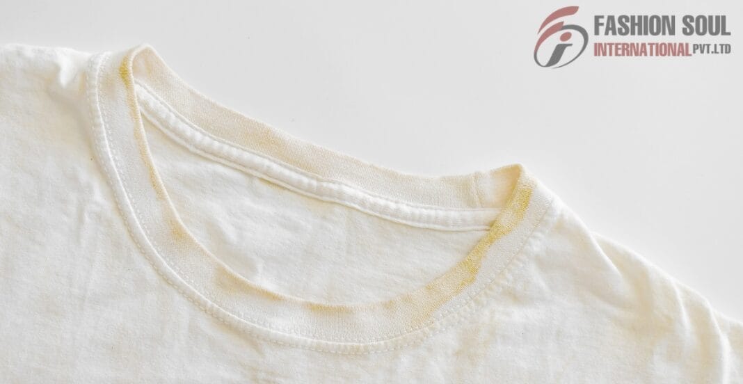 Close-up of a white cotton t-shirt collar with visible yellow sweat stains, placed on a white background.