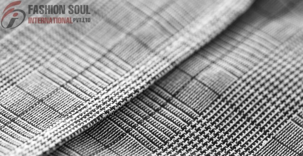 Close-up of black and white checked fabric with a textured pattern created by various intersecting lines.