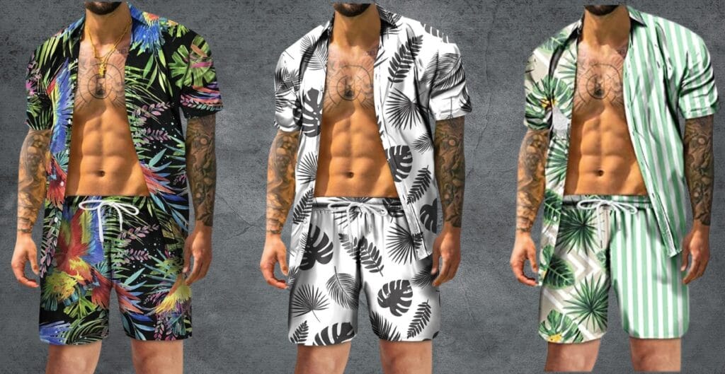 Three men standing side by side, each wearing a matching short-sleeve button-up shirt and shorts set with tropical prints. The man on the left has a vibrant, colorful tropical print. The man in the middle wears a black-and-white tropical pattern. The man on the right has a green and white striped tropical design. All three are shirtless underneath, showcasing their tattoos and athletic builds.