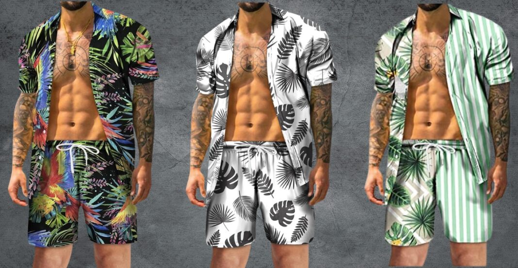 Three men standing side by side, each wearing a matching short-sleeve button-up shirt and shorts set with tropical prints. The man on the left has a vibrant, colorful tropical print. The man in the middle wears a black-and-white tropical pattern. The man on the right has a green and white striped tropical design. All three are shirtless underneath, showcasing their tattoos and athletic builds.