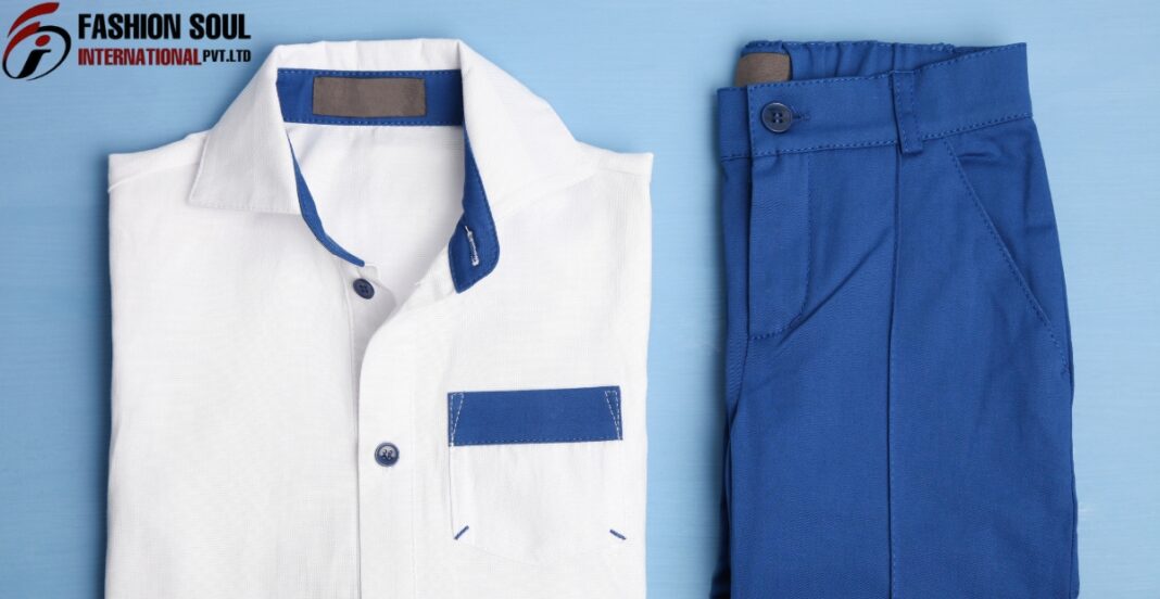 A neatly folded white shirt with blue accents next to a pair of blue trousers, set against a light blue background with the 
