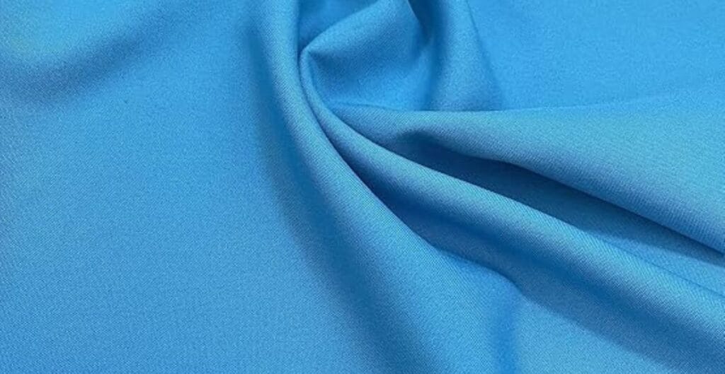 Smooth, sky blue satin fabric with soft folds and a subtle sheen.