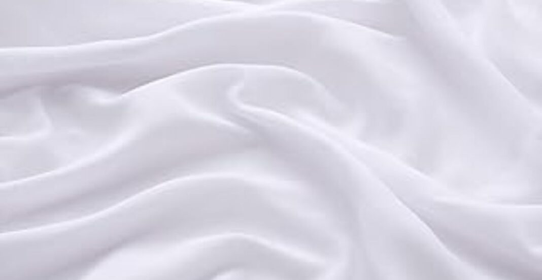 Soft white fabric with gentle folds and flowing drape.