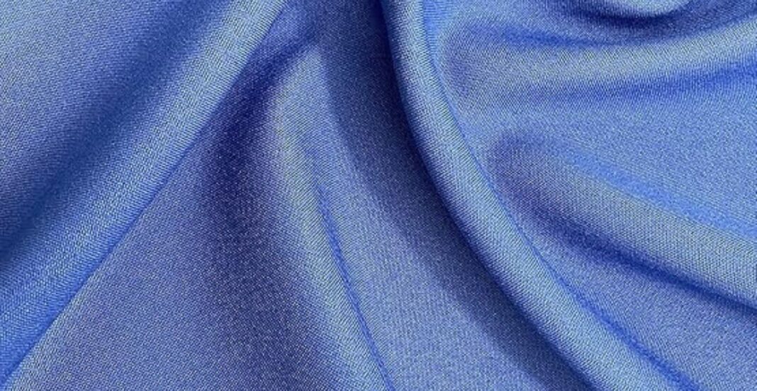 Smooth blue satin fabric with soft folds and a glossy finish.