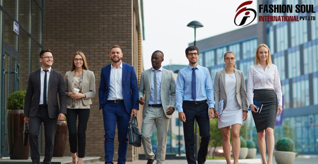 A diverse group of seven business professionals walking confidently outdoors in front of modern office buildings. They are dressed in formal business attire and appear to be engaged and smiling.