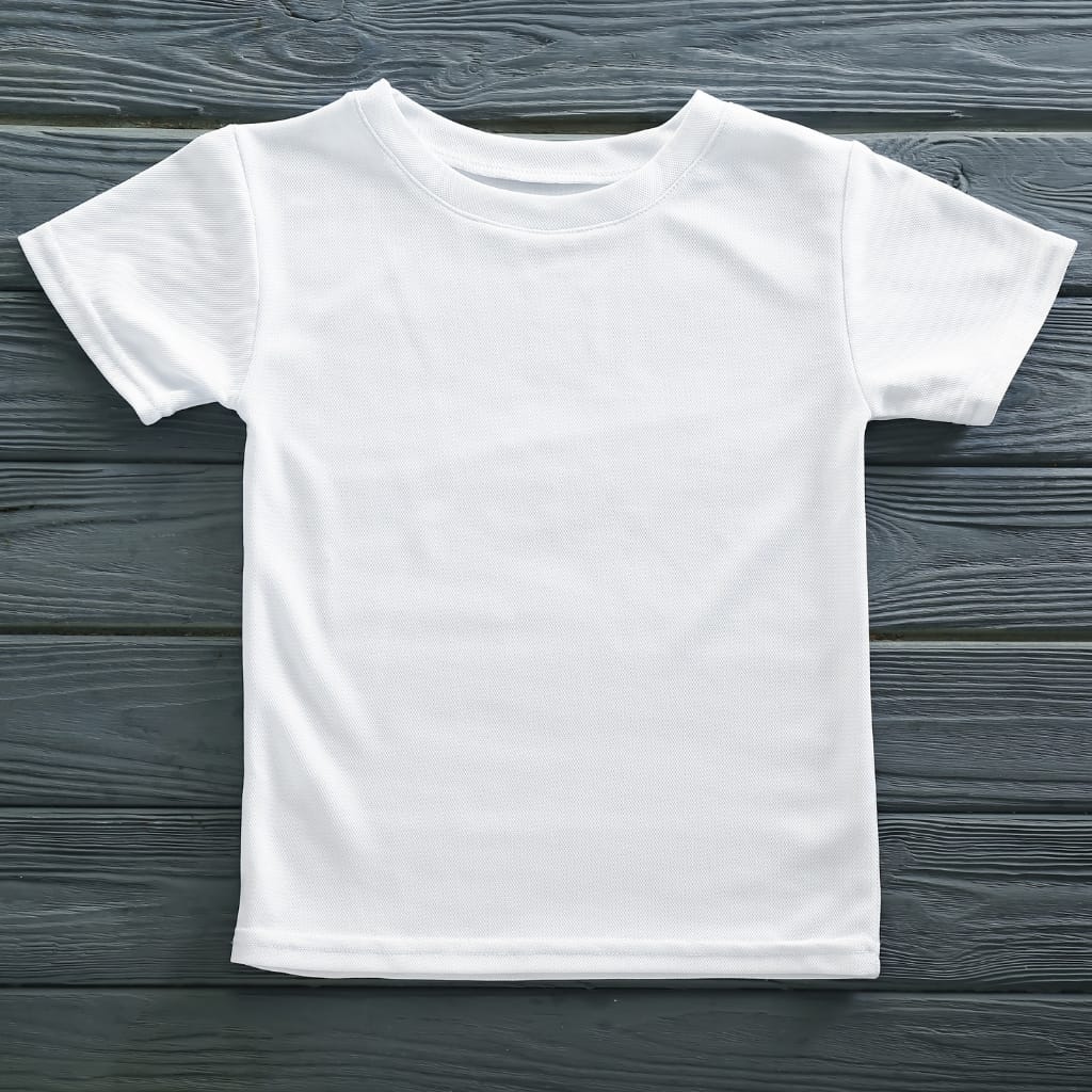 A plain white T-shirt laid flat on a dark wooden surface.