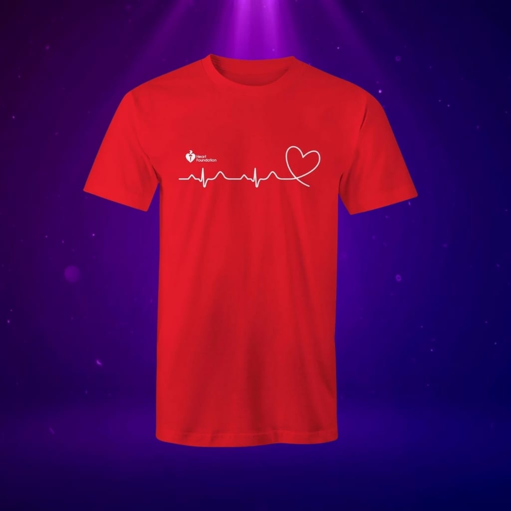 Red t-shirt with white heart and ECG line design, displayed on a glowing purple background.