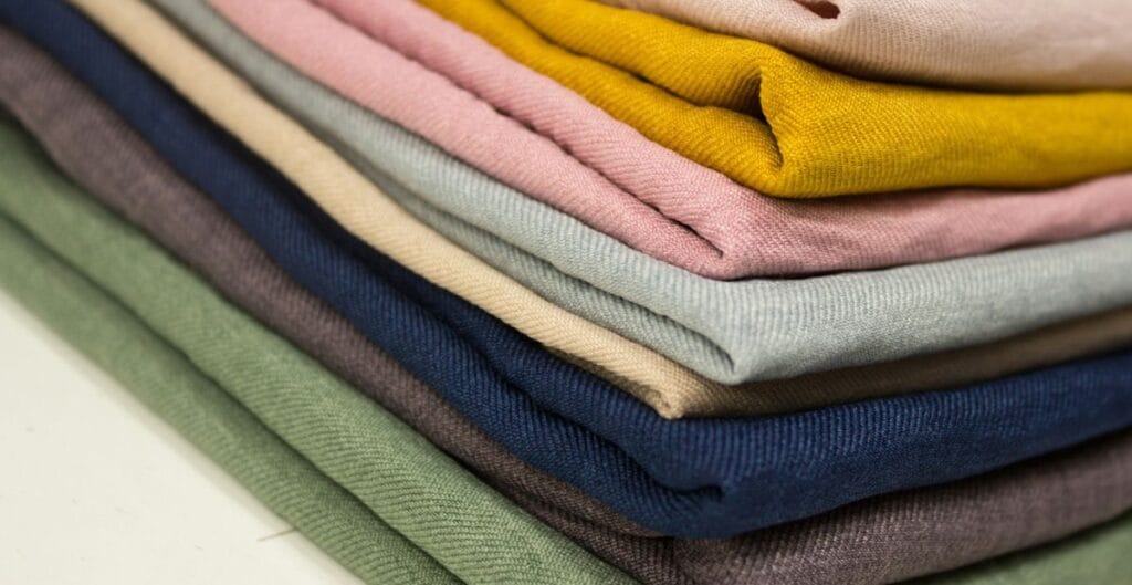 A stack of folded, colorful fabric pieces arranged in a neat pile.