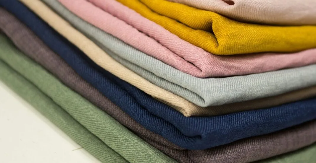 is polyester hot A stack of folded, colorful fabric pieces arranged in a neat pile.